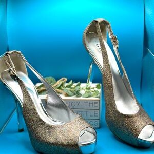 Preowned Guess silver and pink glitter peep toe pumps.